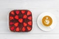 Homemade strawberry tiramisu and cup of coffee cappuccino on white wooden table. Royalty Free Stock Photo