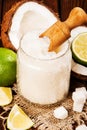 Homemade sugar scrub with lime and coconut on wooden background