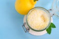 Homemade sugar scrub with olive oil, essential lemon oil and lemon peel. Diy cosmetics. Top view, copy space. Royalty Free Stock Photo