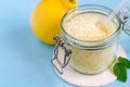 Homemade sugar scrub with olive oil, essential lemon oil and lemon peel. Diy cosmetics. Copy space. Royalty Free Stock Photo