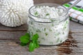 Homemade sugar scrub with vegetable oil, chopped mint leaves and essential mint oil