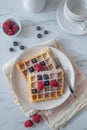 Homemade summer breakfast belgian waffles with berries