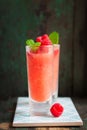 Homemade summer cold raspberry cocktail with crushed iced and alcohol in glasses on a vintage background Royalty Free Stock Photo