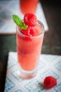 Homemade summer cold raspberry cocktail with crushed iced and alcohol in glasses on a vintage background Royalty Free Stock Photo