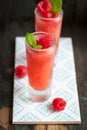 Homemade summer cold raspberry cocktail with crushed iced and alcohol in glasses on a vintage background Royalty Free Stock Photo