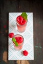 Homemade summer cold raspberry cocktail with crushed iced and alcohol in glasses on a vintage background Royalty Free Stock Photo