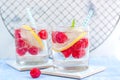 Homemade summer cold raspberry lemon cocktail with sparkling water and crushed iced in glasses Royalty Free Stock Photo