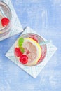 Homemade summer cold raspberry lemon cocktail with sparkling water and crushed iced in glasses Royalty Free Stock Photo