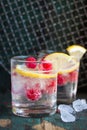 Homemade summer cold raspberry lemon cocktail with sparkling water and crushed iced in glasses on a vintage background Royalty Free Stock Photo