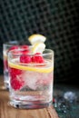 Homemade summer cold raspberry lemon cocktail with sparkling water and crushed iced in glasses on a vintage background Royalty Free Stock Photo