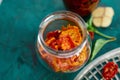 Homemade sun dried tomatoes with herbs, garlic in olive oil in a glass jar Royalty Free Stock Photo