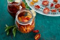 Homemade sun dried tomatoes with herbs, garlic in olive oil in a glass jar Royalty Free Stock Photo