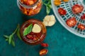 Homemade sun dried tomatoes with herbs, garlic in olive oil in a glass jar Royalty Free Stock Photo