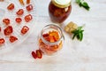 Homemade sun dried tomatoes with herbs, garlic in olive oil in a glass jar Royalty Free Stock Photo