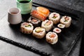 Homemade sushi rolls with salmon, shrimp, avocado. Served with soy sauce and ginger. Royalty Free Stock Photo