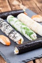 Homemade sushi rolls on a slate board