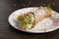 Homemade sweet cannoli filled with ricotta cream and a Sicilian pistachio dessert. Sicilian Italian cake. Isolated image