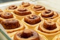 Homemade sweet cinnamon rolls. Closeup of freshly cooked buns