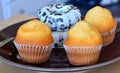 Homemade sweet muffins and donuts on a plate.