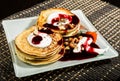 Homemade sweet pancakes with fruit jam, sour cream on a white plate. Breakfast with stack topped blueberry jam and Royalty Free Stock Photo