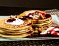 Homemade sweet pancakes with fruit jam, sour cream on a white plate. Breakfast with stack topped blueberry jam and Royalty Free Stock Photo