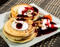 Homemade sweet pancakes with fruit jam, sour cream on a white plate. Breakfast with stack topped blueberry jam and Royalty Free Stock Photo