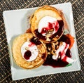 Homemade sweet pancakes with fruit jam, sour cream on a white plate. Breakfast with stack topped blueberry jam and Royalty Free Stock Photo