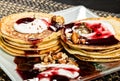 Homemade sweet pancakes with fruit jam, sour cream on a white plate. Breakfast with stack topped blueberry jam and Royalty Free Stock Photo