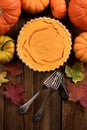 Homemade sweet pumpkin pie in cast iron pan with vintage forks on wooden background rustic style top view Royalty Free Stock Photo