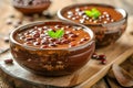 Homemade Sweet Red Bean Soup with Fresh Mint Garnish Served in Rustic Bowls on Wooden Background