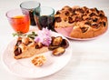 Homemade sweet round plum cake New York Times and cut n saucer with cups, glasses of tea, coffee on family holyday Breakfast or bi Royalty Free Stock Photo