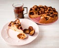 Homemade sweet round plum cake New York Times and cut n saucer with cups, glasses of tea, coffee on family holyday Breakfast or bi Royalty Free Stock Photo