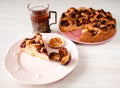 Homemade sweet round plum cake New York Times and cut n saucer with cups, glasses of tea, coffee on family holyday Breakfast or bi Royalty Free Stock Photo