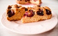 Homemade sweet round plum cake New York Times cutted on plate with cups, glasses of tea, coffee at back on holyday Breakfast or bi Royalty Free Stock Photo