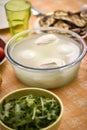 Table set with a bowl with buffalo mozzarella in the center and in the background the ingredients for the Mediterranean d