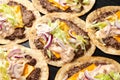 Homemade Taco smash burger with sauce, cheese, lettuce and red onion Royalty Free Stock Photo