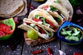 Homemade tacos with minced meat in tomato sauce with fresh tomatoes, cucumbers, chili and soft cheese. Mexican food. Royalty Free Stock Photo