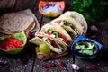 Homemade tacos with minced meat in tomato sauce with fresh tomatoes, cucumbers, chili and soft cheese. Mexican food. Royalty Free Stock Photo