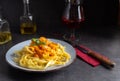 Homemade tagliatelle with diabolo sauce with shrimps on a plate