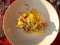Homemade tagliatelle with speck and vegetables