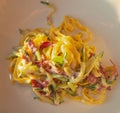 Homemade tagliatelle with speck and vegetables