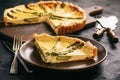 Homemade tart with asparagus and cheese on black background.