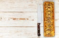 Homemade tart with mushrooms, leek, cheese and thyme on white rustic background. Traditional snack cake and a knife on the table Royalty Free Stock Photo