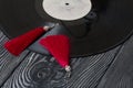 Homemade tassel earrings in red. Against the background of old vinyl records and brushed pine boards painted in black and white Royalty Free Stock Photo