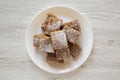 Homemade Tasty Applesauce Cake on a white plate on a white wooden table, top view. Flat lay, from above, overhead