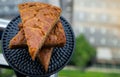 Homemade tasty banana cake slices on Black ceramic plate with city view Royalty Free Stock Photo