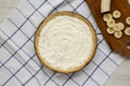 Homemade Tasty Banana Cream Pie on a white wooden surface, top view. Flat lay, overhead, from above. Copy space