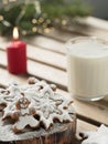 Homemade tasty christmas gingerbread cookies with glass of milk on brown wooden background. Close-up. Branches of a Christmas tree Royalty Free Stock Photo