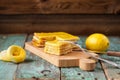 Homemade tasty layered lemon cake and whole and squeezed lemons