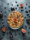 Homemade tasty muesli with nuts in glass bowl, berries and figs fruits. Healthy vegetarian breakfast. Royalty Free Stock Photo